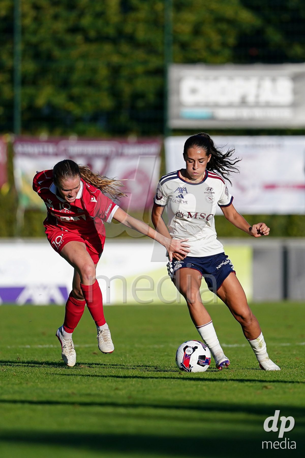 Rapperswil, Switzerland - September 12: Amina Muratovic (Amina Muratović) of Servette FC Chenois Feminin (R) and Leyla Mcfarland of FC Rapperswil-Jona (L) battle for the ball during the AXA Women's Super League match between FC Rapperswil-Jona and Servette FC Chenois Feminin at Stadion Grünfeld on September 12, 2026 in Rapperswil, Switzerland.