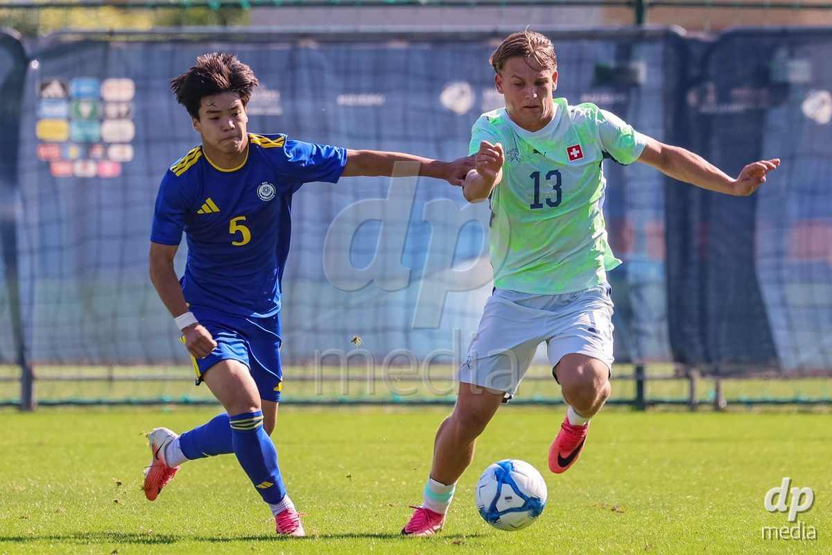 DUNAJSKA LUZNA, SLOVAKIA - SEPTEMBER 28: Justin Englin 13 of Switzerland struggle for the ball during the friendly international football match between Kazakhstan U19 and Switzerland U19 on September 28, 2026 in Dunajska Luzna, Slovakia.