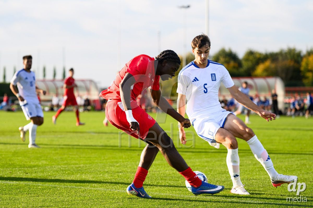 KOSMONSY, CZECH REPUBLIC - SEPTEMBER 30: Shedrach Ogbodu of Switzerland a Andreas Poulopoulos of Greece during the International Friendly match between Switzerland U18 and Greece U18 on September 30, 2026 in Kosmonsy, Czech Republic.