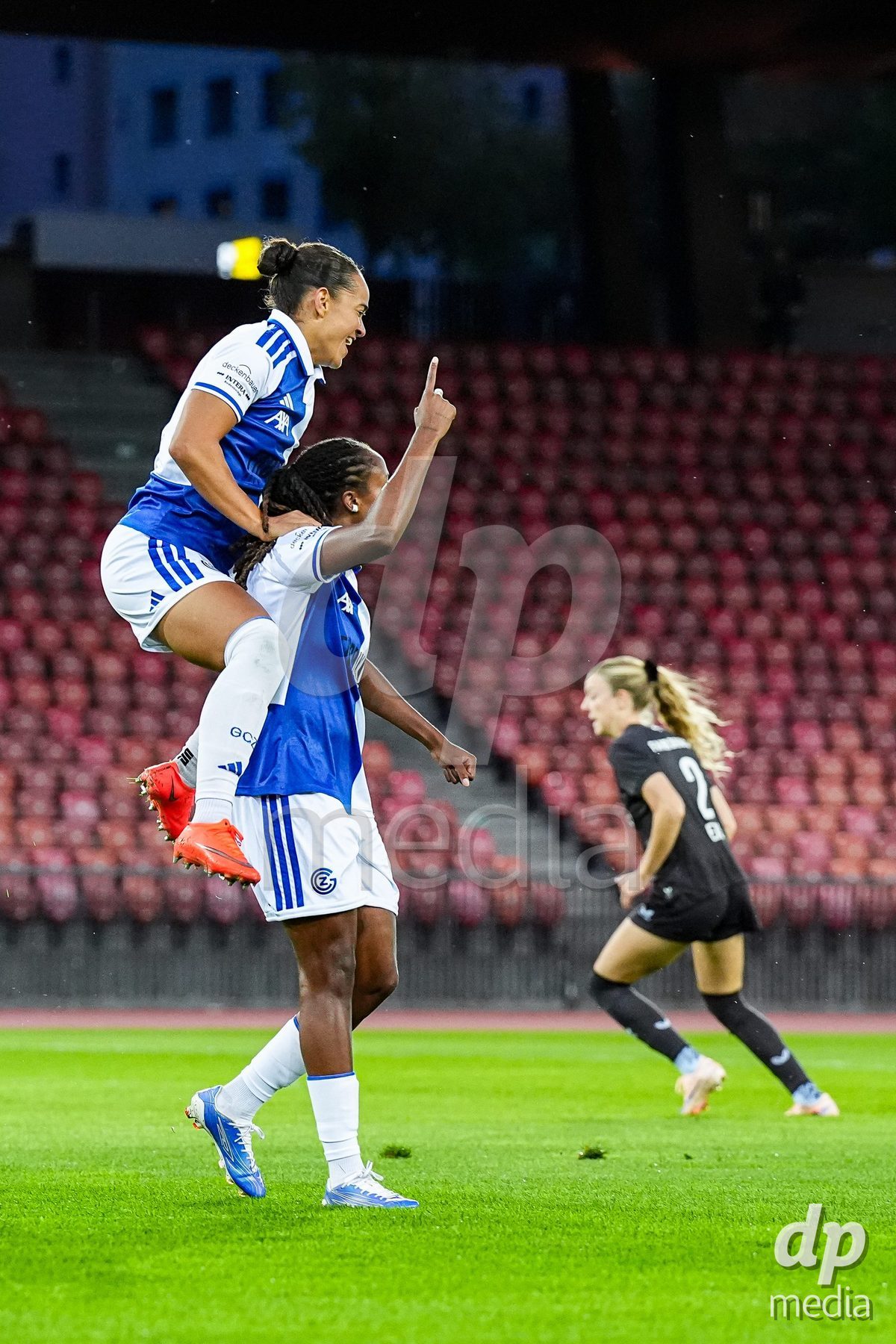 ZURICH, SWITZERLAND - OCTOBER 2: Kayla Mckenna of Grasshopper Club Zurich celebrates with teammates after scoring her teams first goal during the AXA Women's Super League match between GC Frauenfussball and FC Zurich at Letzigrund on October 2, 2026 in Zurich, Switzerland.