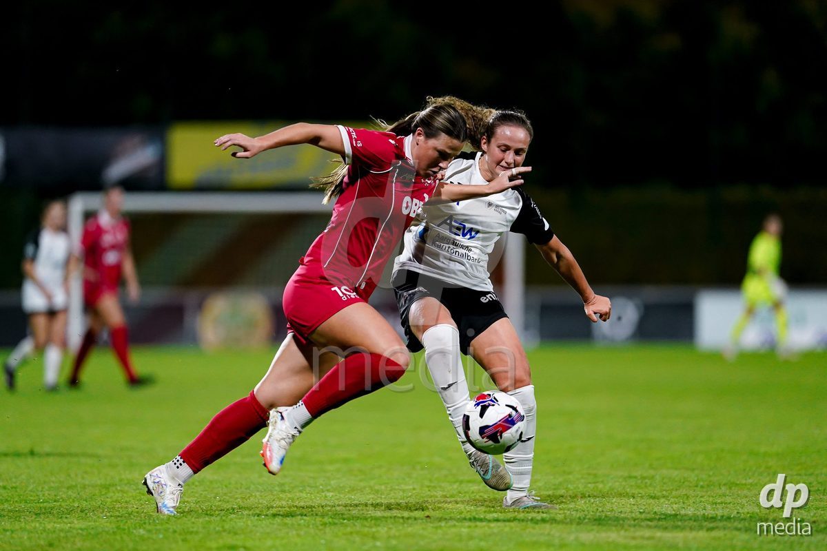 RAPPERSWIL, SWITZERLAND - OCTOBER 3: Martina Cocino of FC Aarau Frauen (R) and Olivia Halina Borgen of FC Rapperswil-Jona (L) battle for the ball during the AXA Women's Super League match between FC Rapperswil-Jona and FC Aarau Frauen at Grunfeld on October 3, 2026 in Rapperswil, Switzerland.