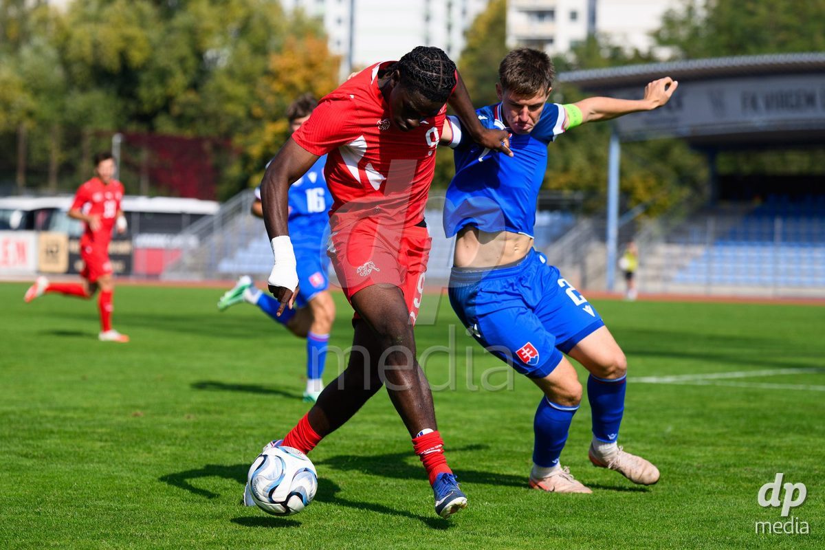 USTI NAD LABEM, CZECH REPUBLIC - OCTOBER 3: Shedrach Ogbodu of Switzerland (left) and Simon Hubona of Slovakia during the International Friendly match between Slovakia and Switzerland on October 3, 2026 in Ustí nad Labem, Czech Republic.