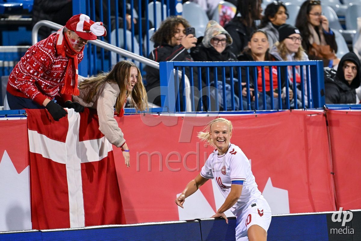 MONTREAL, CANADA - OCTOBER 9: Pernille Harder of Denmark celebrates with a fan after scoring her teams first goal during the International Women's Friendly football match between Canada and Denmark at Stade Saputo on October 9, 2026 in Montreal, Canada.