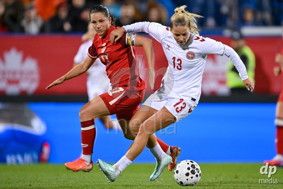 MONTREAL, CANADA - OCTOBER 9: Jessie Fleming of Canada (L) and Olivia Holdt of Denmark (R) battle for the ball (duel)  during the International Women's Friendly football match between Canada and Denmark at Stade Saputo on October 9, 2026 in Montreal, Canada.