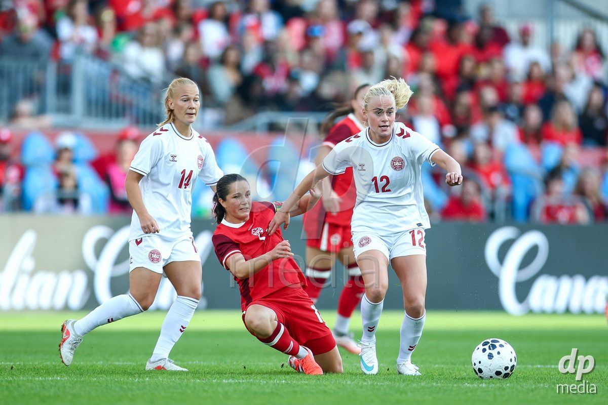 TORONTO, CANADA - OCTOBER 12: Jessie Fleming of Canada (L) and Kathrine Kühl of Denmark (R) battle for the ball (duel) during the International Friendly match between Canada and Denmark at BMO Field on October 12, 2026 in Toronto, Canada.