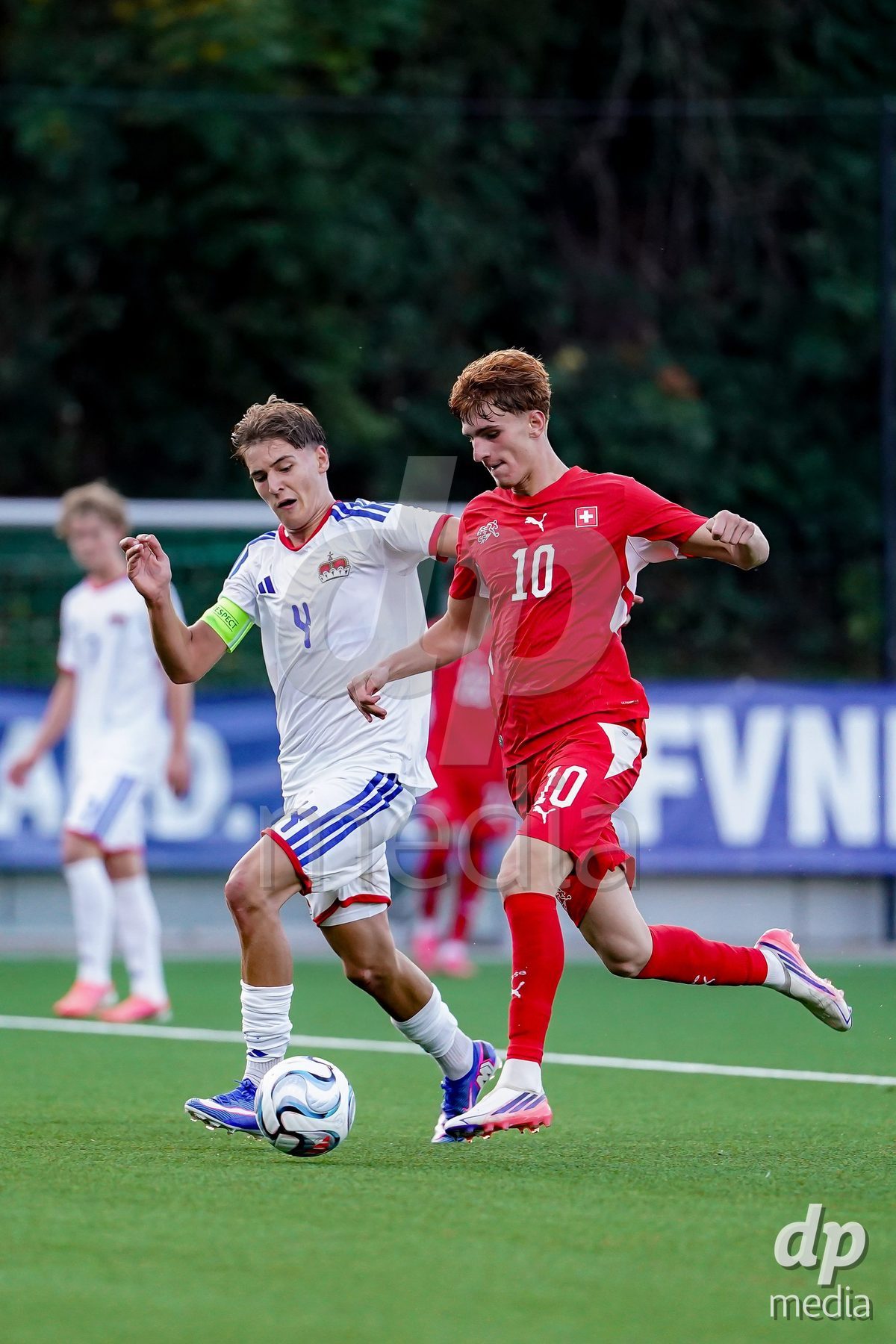 SCHAAN, LIECHTENSTEIN - OCTOBER 15: Eron Kele of Switzerland and Alexander Matheis of Liechtenstein battle for the ball during the UEFA European Under-17 Qualifier match between Switzerland and Liechtenstein at LFV Campus Rheinwiese on October 15, 2026 in Schaan, Liechtenstein.