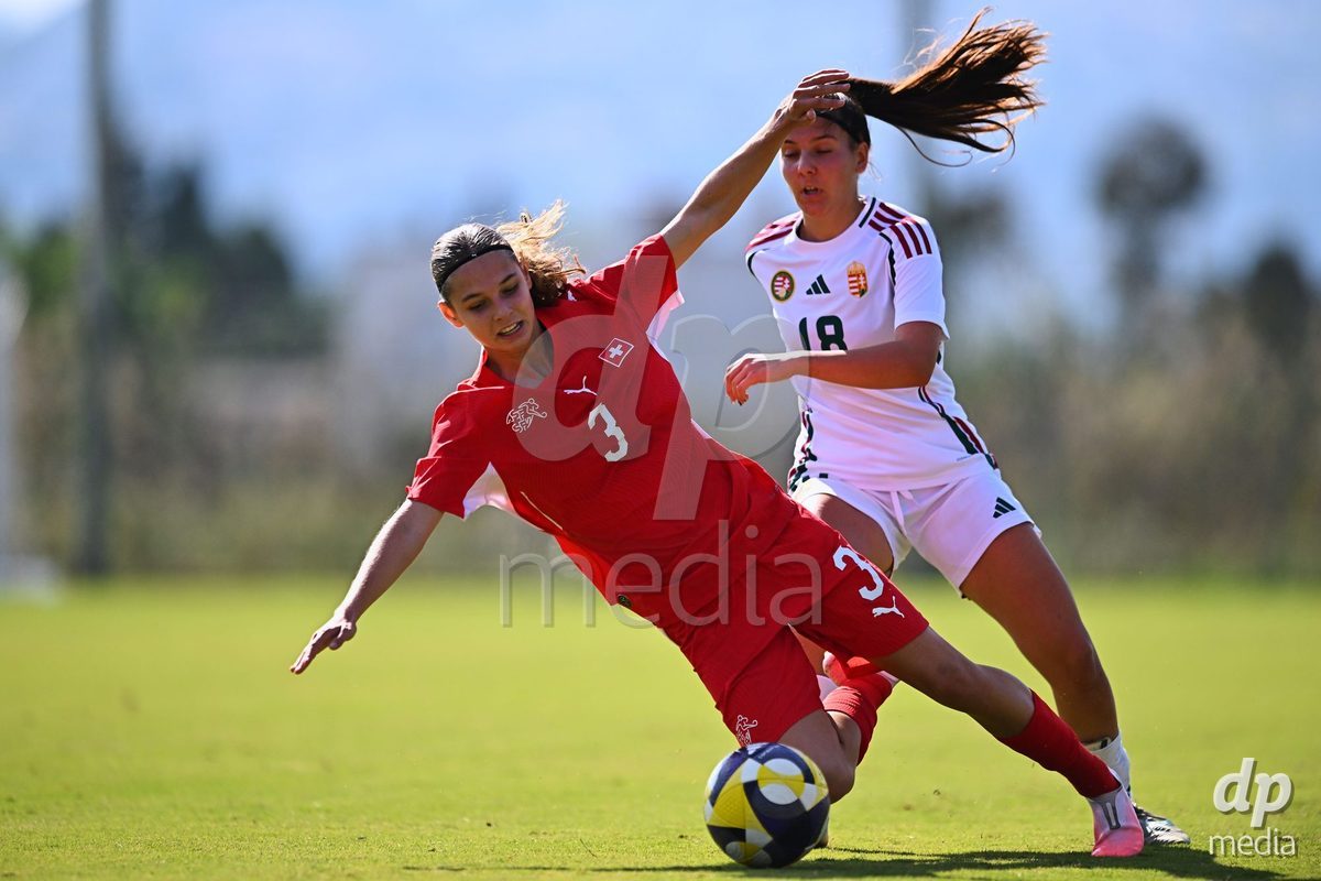 OLIVA NOVA, SPAIN - OCTOBER 22: Louise Schule of Switzerland competes for the ball with Virag Sipos-Kiss of Hungary during the International Women's Friendly match between Hungary U17 and Switzerland U17 at Oliva Nova Sports Center on October 22, 2026 in Oliva Nova, Spain.
