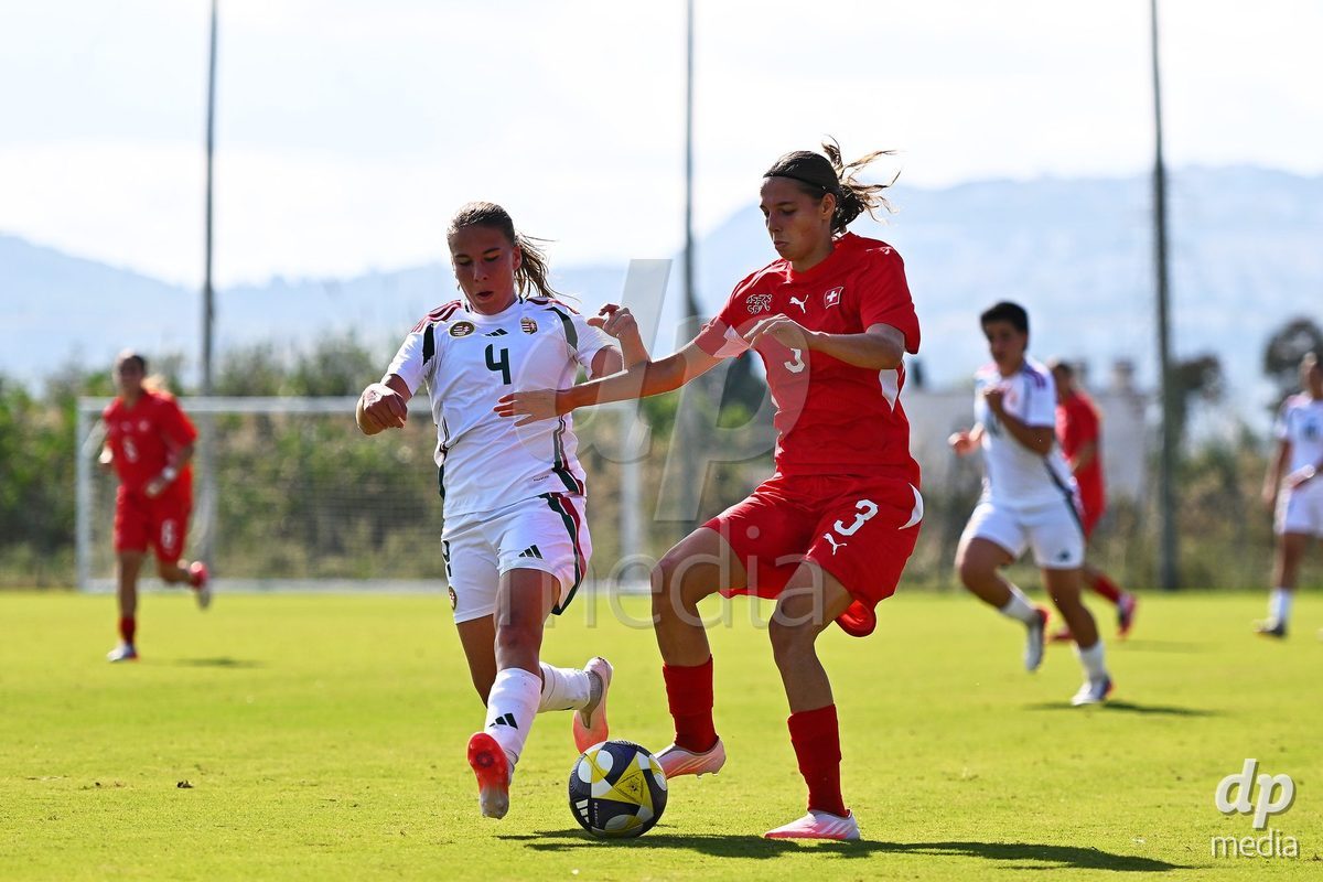 OLIVA NOVA, SPAIN - OCTOBER 22: Louise Schule of Switzerland competes for the ball with Luca Magyar of Hungary during the International Women's Friendly match between Hungary U17 and Switzerland U17 at Oliva Nova Sports Center on October 22, 2026 in Oliva Nova, Spain.