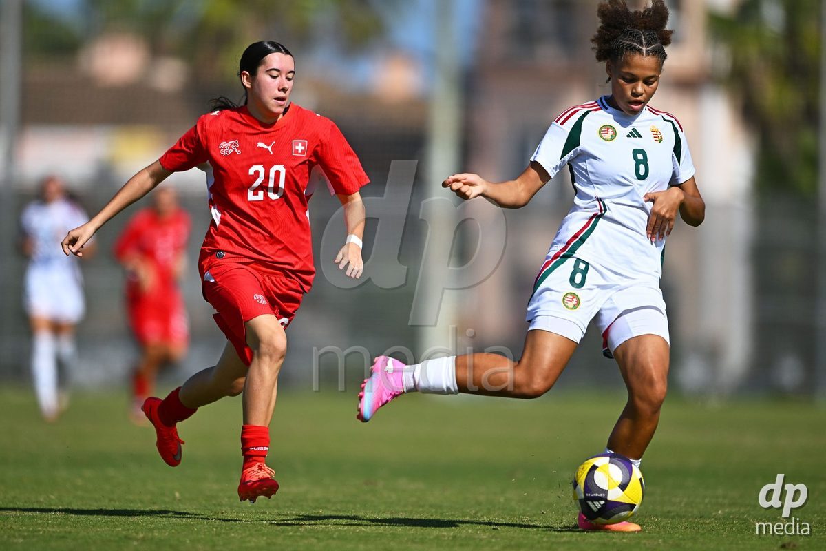 OLIVA NOVA, SPAIN - OCTOBER 22: Lucie Klopfenstein of Switzerland competes for the ball with Messenga Amelie of Hungary during the International Women's Friendly match between Hungary U17 and Switzerland U17 at Oliva Nova Sports Center on October 22, 2026 in Oliva Nova, Spain.
