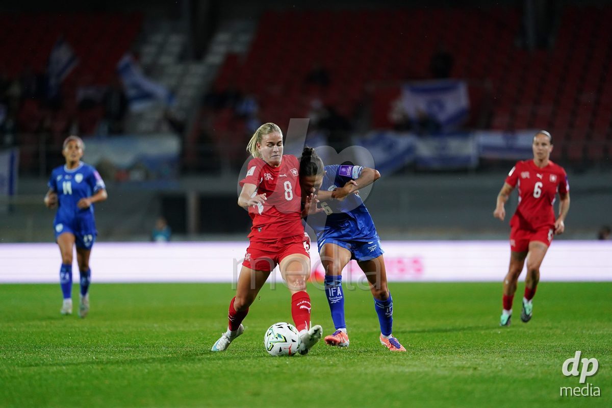 SION, SWITZERLAND - OCTOBER 13: Shahar Nakav of Israel and Nadine Riesen of Switzerland battle for the ball during the FIFA Women´s World Cup European Qualifiers match between Switzerland and Israel at Stade de Tourbillon on October 13, 2026 in Sion, Switzerland.