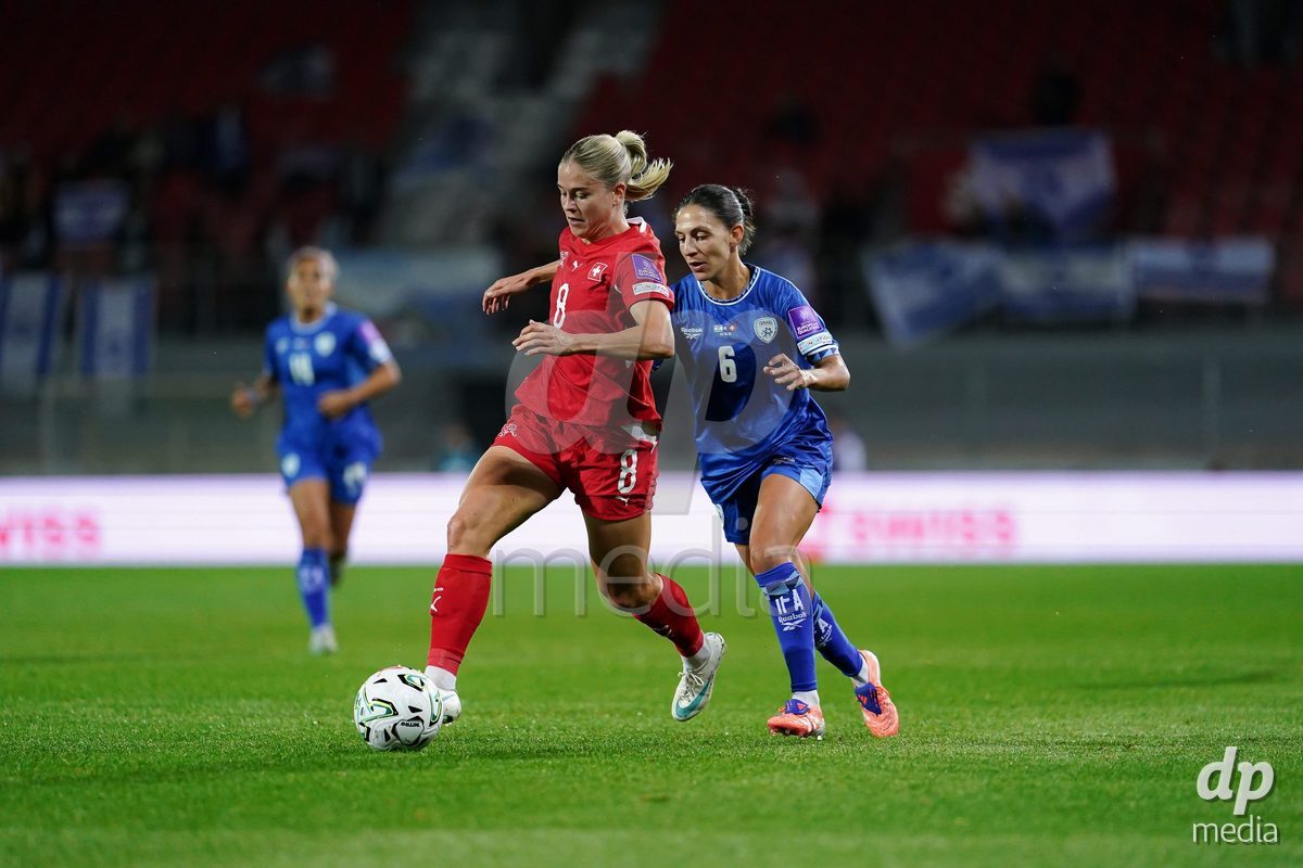 SION, SWITZERLAND - OCTOBER 13: Shahar Nakav of Israel and Nadine Riesen of Switzerland battle for the ball during the FIFA Women´s World Cup European Qualifiers match between Switzerland and Israel at Stade de Tourbillon on October 13, 2026 in Sion, Switzerland.