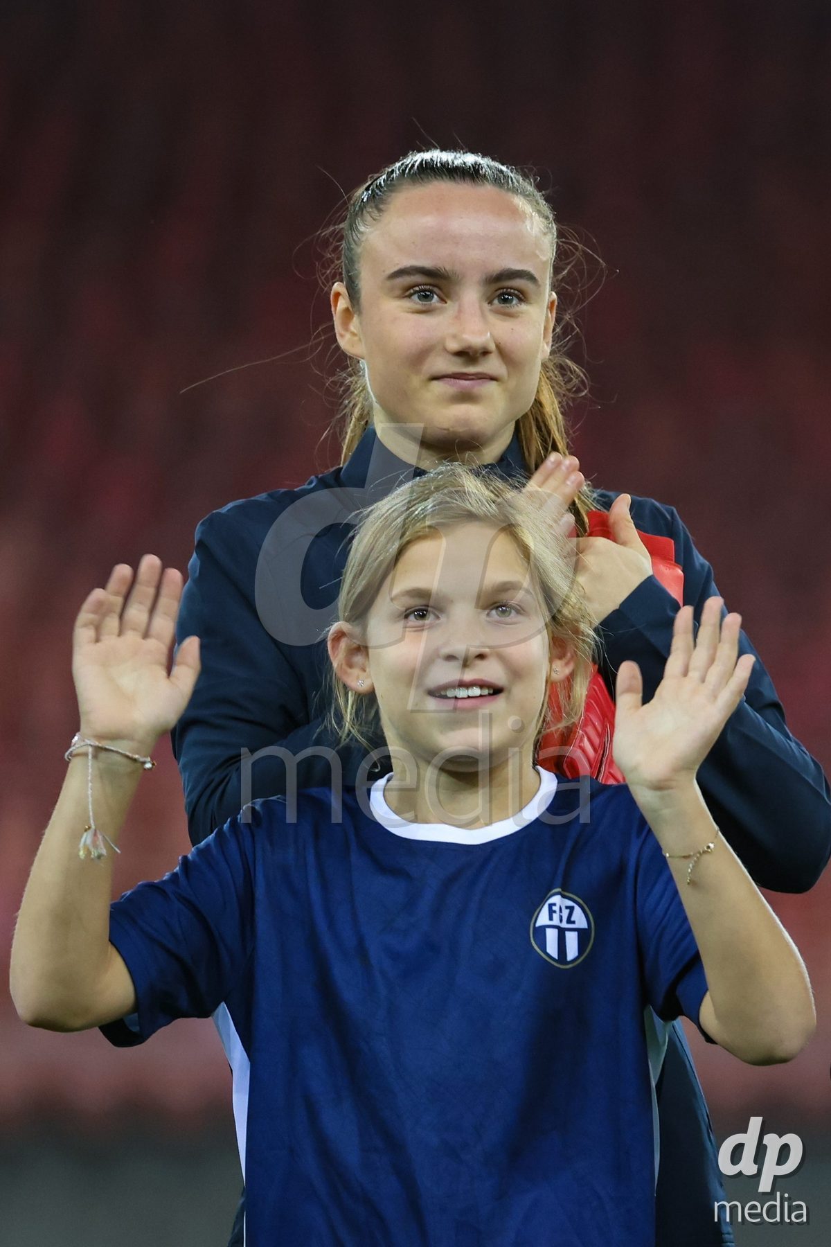 ZURICH, SWITZERLAND - OCTOBER 16: Riana Gmür (21, FC Zürich Frauen) and th Girl player escort during the AXA Women's Super League match between FC Zurich and FC St. Gallen 1879 at Letzigrund on October 16, 2026 in Zurich, Switzerland.